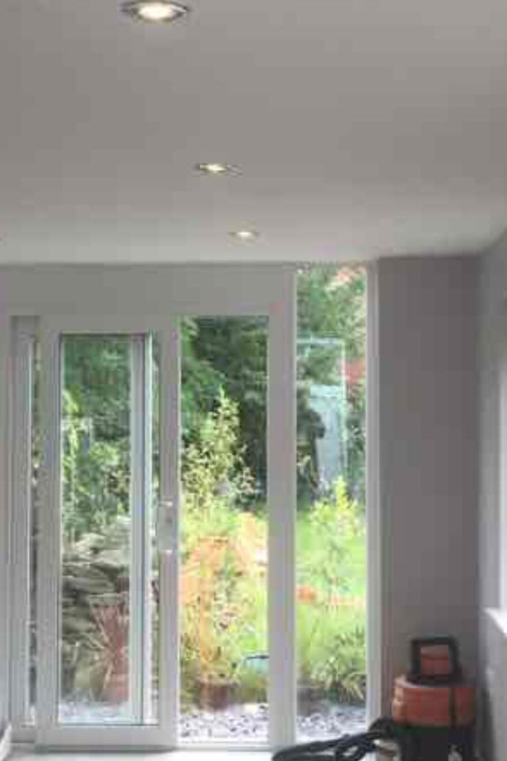 Bright interior room with new French doors looking out to the garden