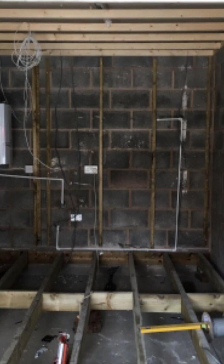 Garage interior showing new floor joists and blockwork during conversion