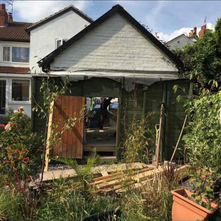 Old timber garden building being stripped back before a garage and outbuilding conversion