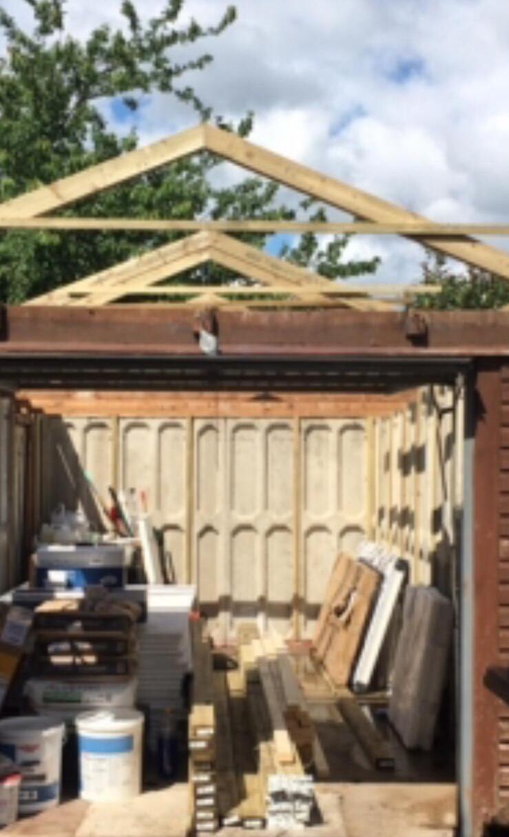 New timber roof trusses being installed on a garage conversion