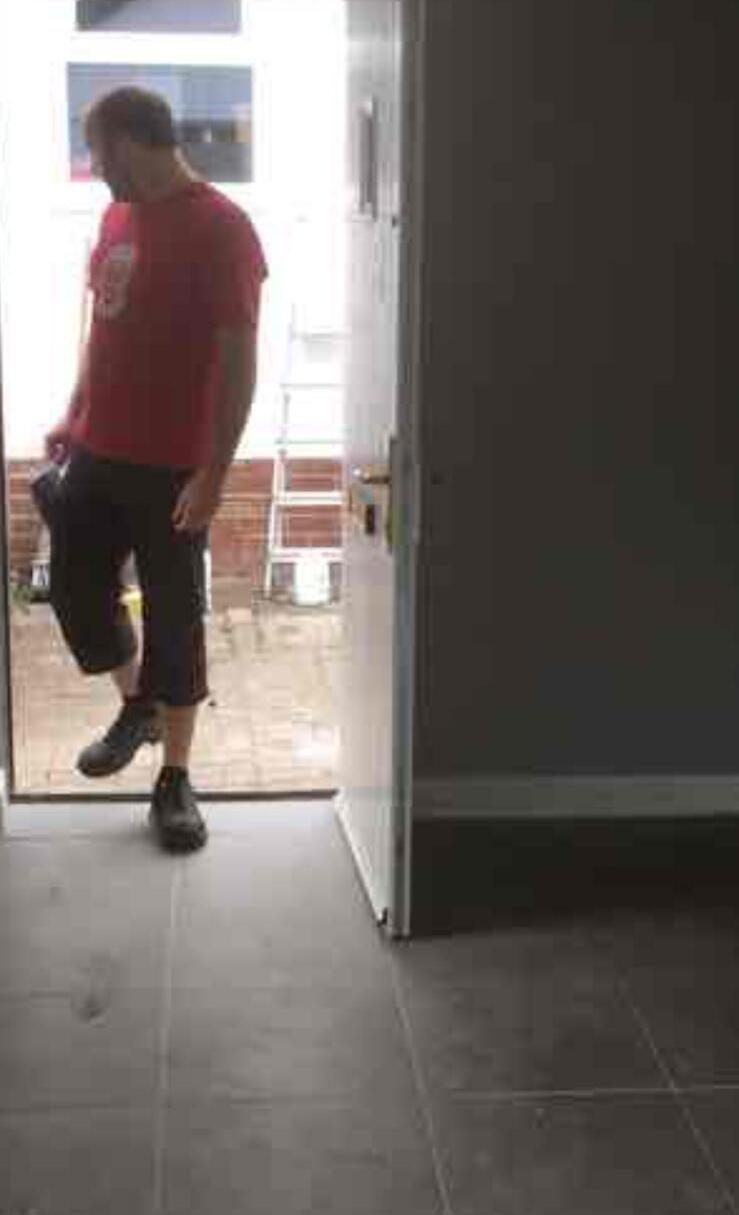 Newly fitted external door with a person stepping through the opening