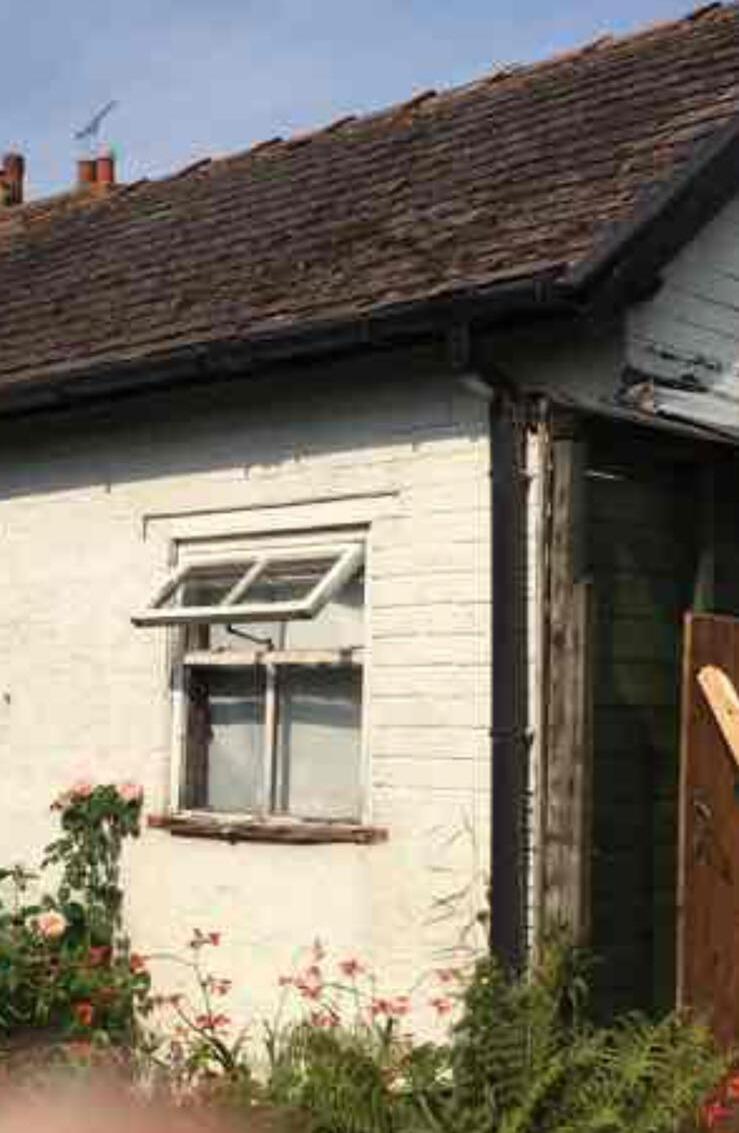 White rendered cottage exterior with new window and roofline