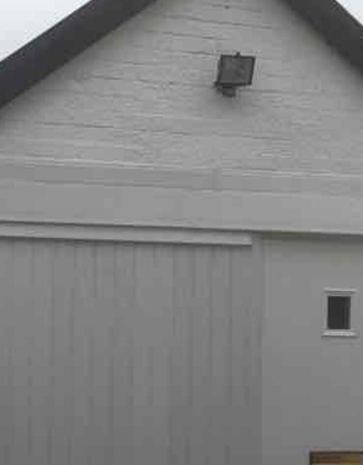Smooth grey rendered single storey extension with a new roof