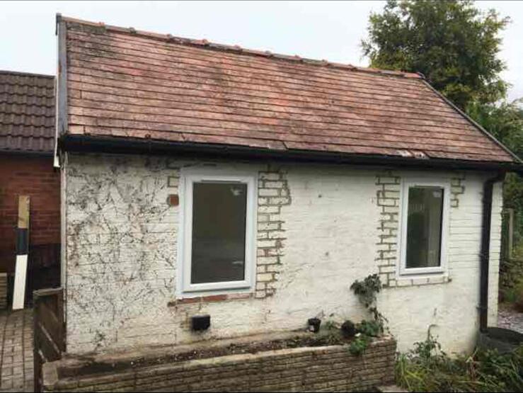 Rendered bungalow exterior with a newly fitted window